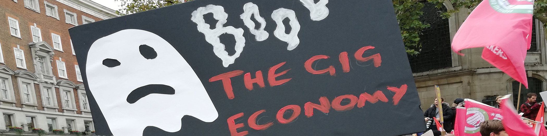 Sign saying 'Boo the gig economy'
