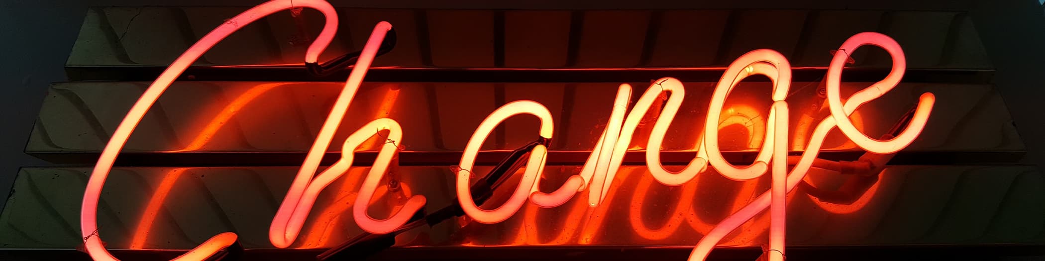 A neon red sign saying change